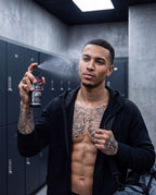 Athlete in a locker room spraying UNS skin cleansing spray